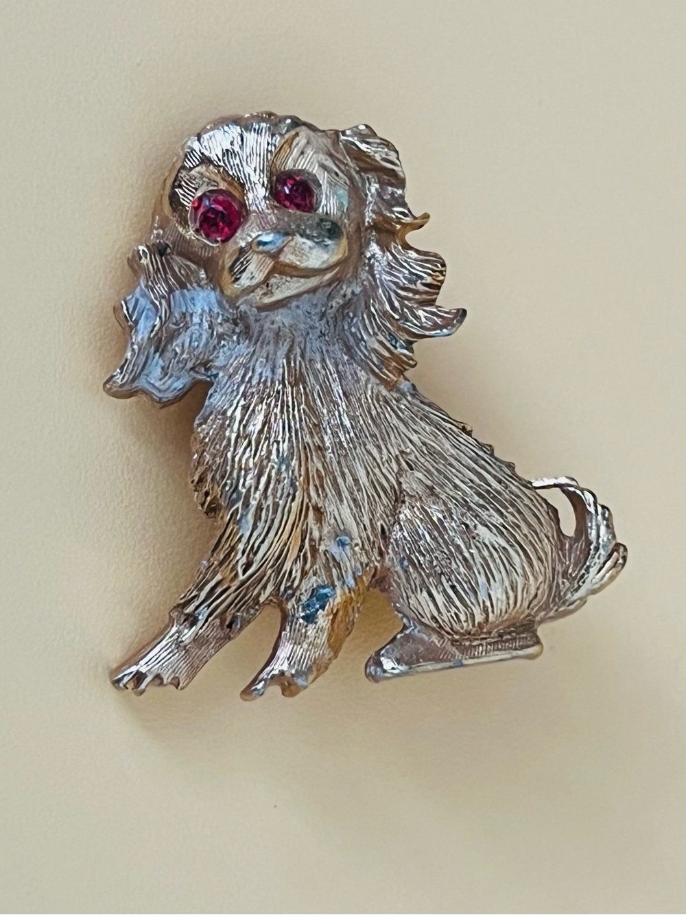 Gold tone Dog brooch with red rhinestones eyes